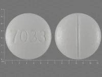 Pill with imprint 7033, white, round, 6 mm (Fludrocortisone Acetate 0.1 mg)