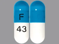 Pill with imprint F 43, blue & white, capsule, 14 mm (Atomoxetine 25 mg)