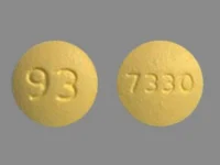 Pill with imprint 93 7330, yellow, round, 9 mm (Fenofibrate 54 mg)