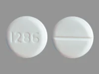 Pill with imprint 1286, white, round, 10 mm (Baclofen 20 mg)