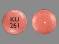 Pill with imprint KU 261, pink, round, 10 mm (Nifedipine 60 mg)