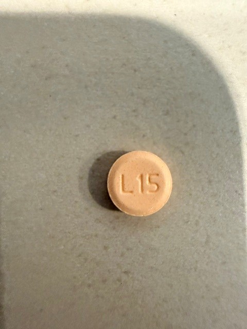 Pill with imprint L15, orange, round, 6 mm (Levothyroxine 0.025 mg)