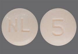 Pill with imprint NL 5, brown, round, 7 mm (Nebivolol 5 mg)